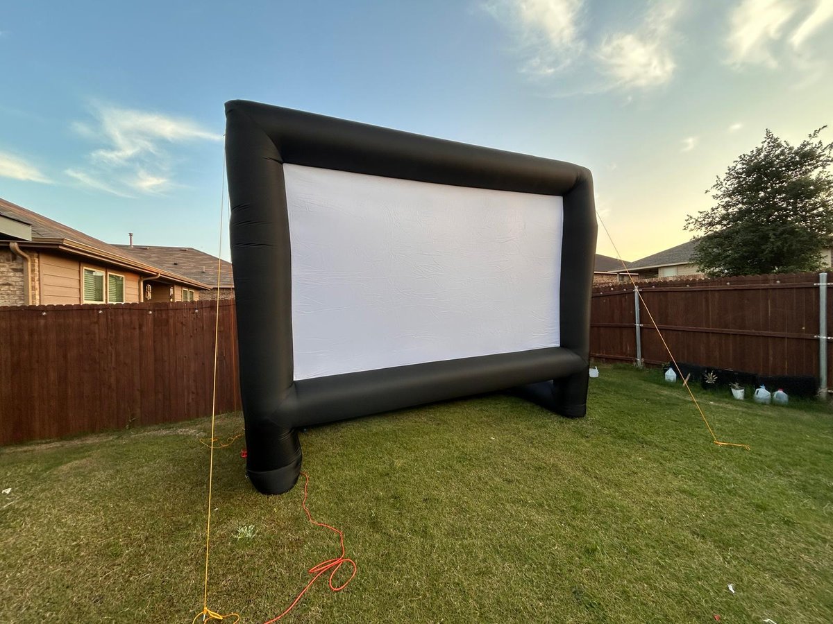 Inflatable movie screen set up by SmartProAV in a Dallas backyard at dusk