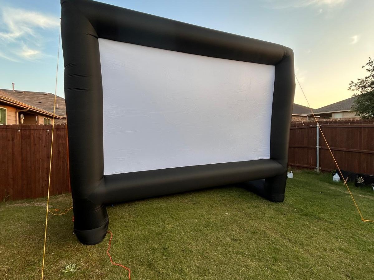 Inflatable outdoor movie screen with dramatic Texas sky